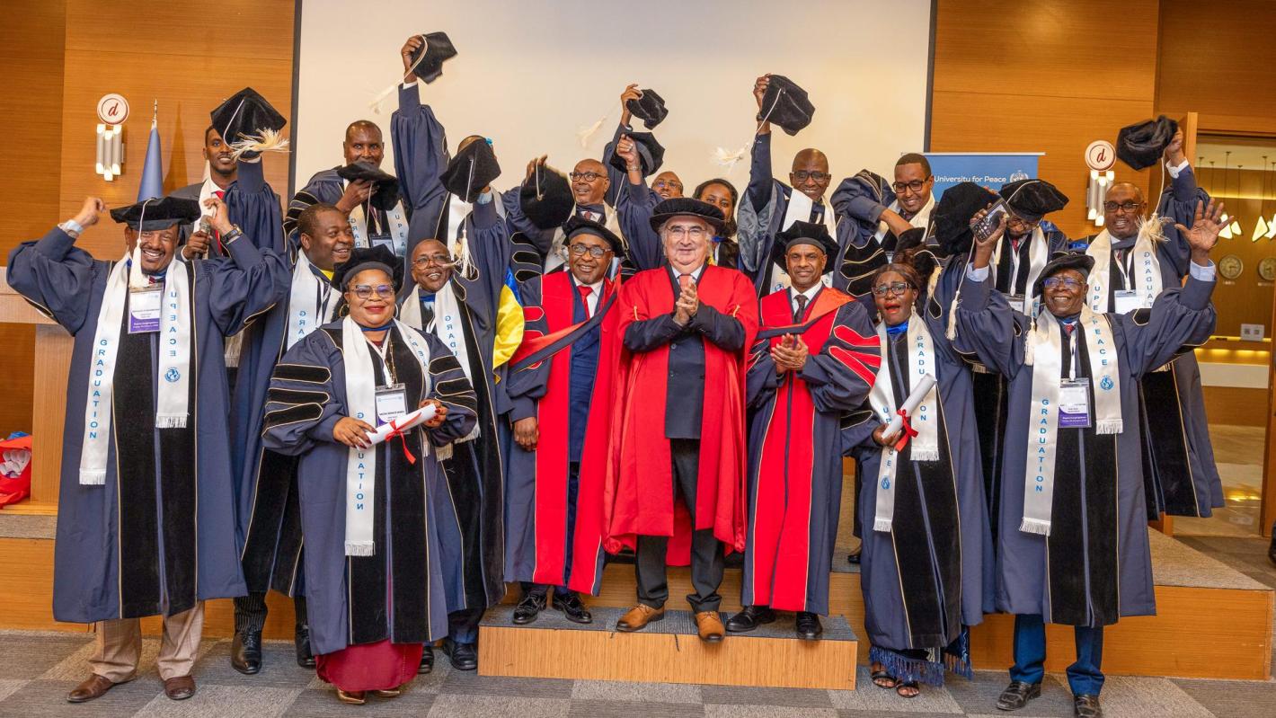 A group of graduates raise their mortarboards with UPEACE Senior officials at the fourth UPEACE graduation ceremony held in Mogadishu, Somalia, on 24 January 2025.