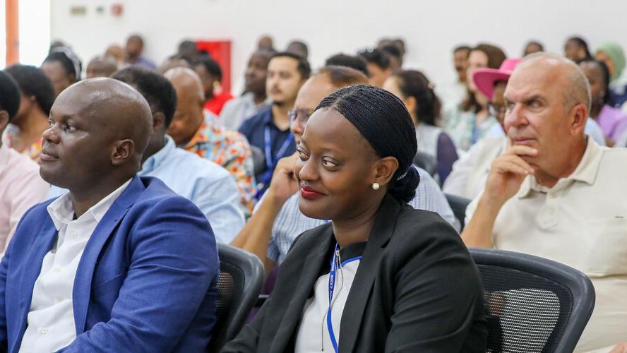 An audience of people listening to a speaker on stage (not pictured).
