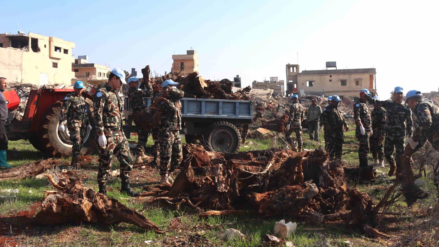 Peacekeepers assist Blida residents to prepare field for olive plantation Peacekeepers assist Blida residents to prepare field for olive plantation