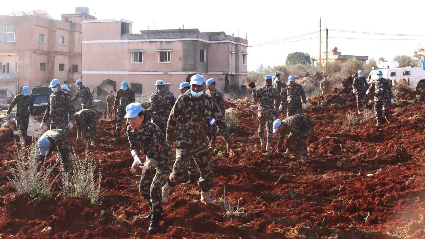 Peacekeepers assist Blida residents to prepare field for olive plantation Peacekeepers assist Blida residents to prepare field for olive plantation