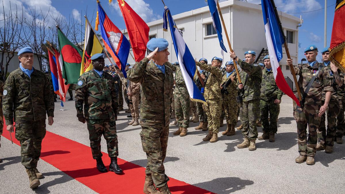 Peacekeepers salute during a procession.