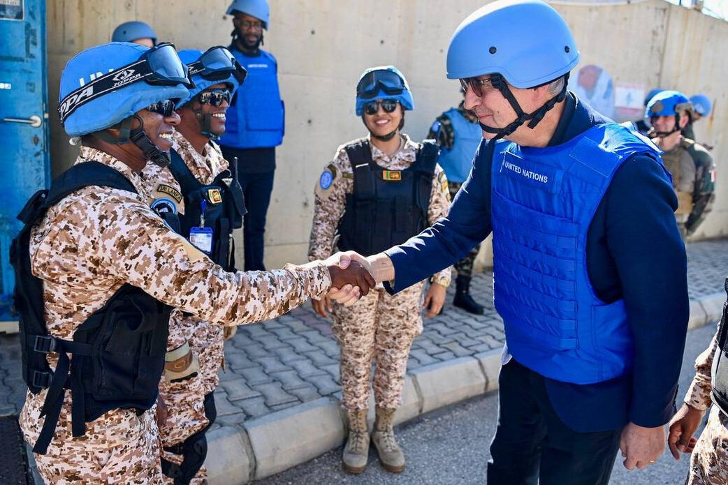 Jean-Pierre Lacroix shakes hands with a peacekeeper.