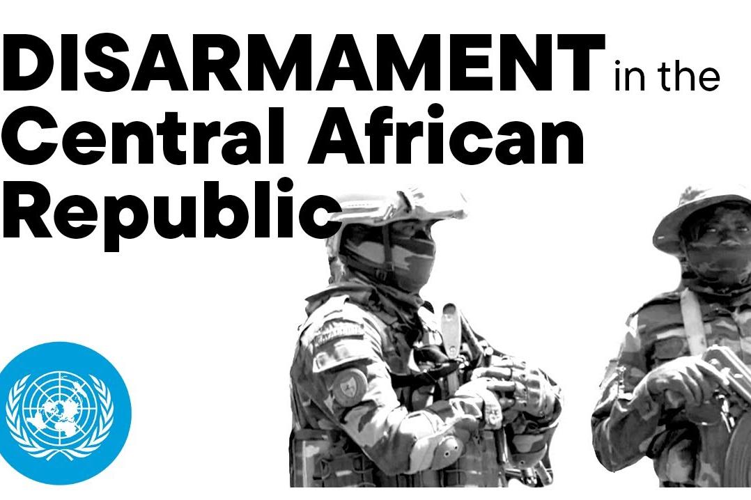 Two men in uniform carrying weapons.