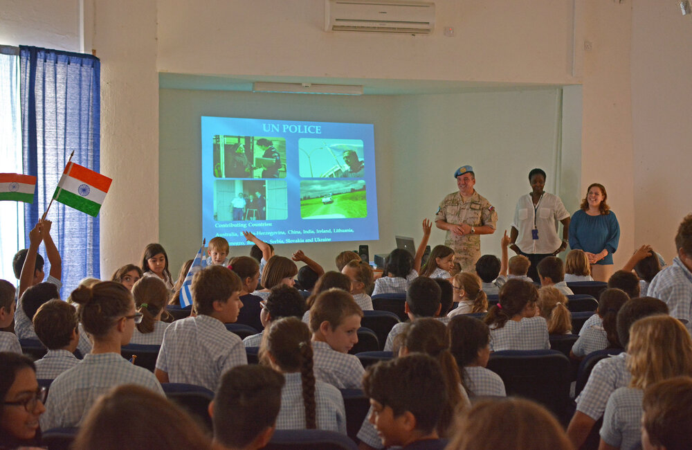 Students of the Falcon School in Nicosia attend a presentation by UNFICYP civilian and military personnel on the history and work of the UN in Cyprus on 23 October 2015, a day ahead of the UN's 70th Anniversary.     UNFICYP/Juraj Hladky