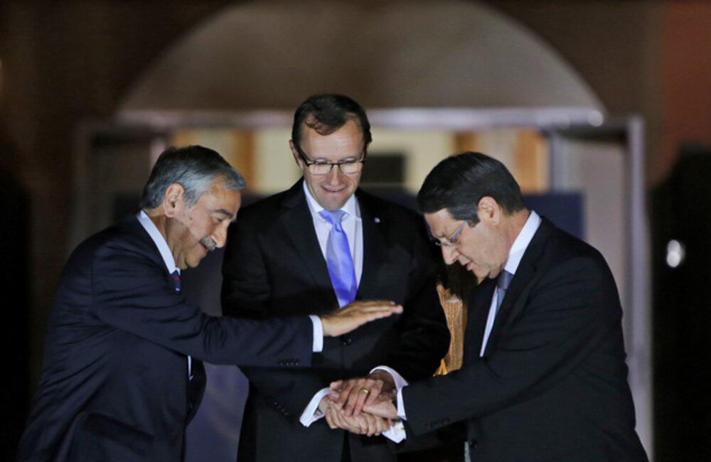The Greek Cypriot leader, Mr. Nicos Anastasiades, Turkish Cypriot leader Mr. Mustafa Akinci, and the Special Adviser of the UN Secretary-General on Cyprus, Espen Barth Eide, shake hands after a dinner at the Ledra Palace Hotel on 11 May 2015, ahead of the resumption of negotiations on 15 May 2015. Photo credit: AP